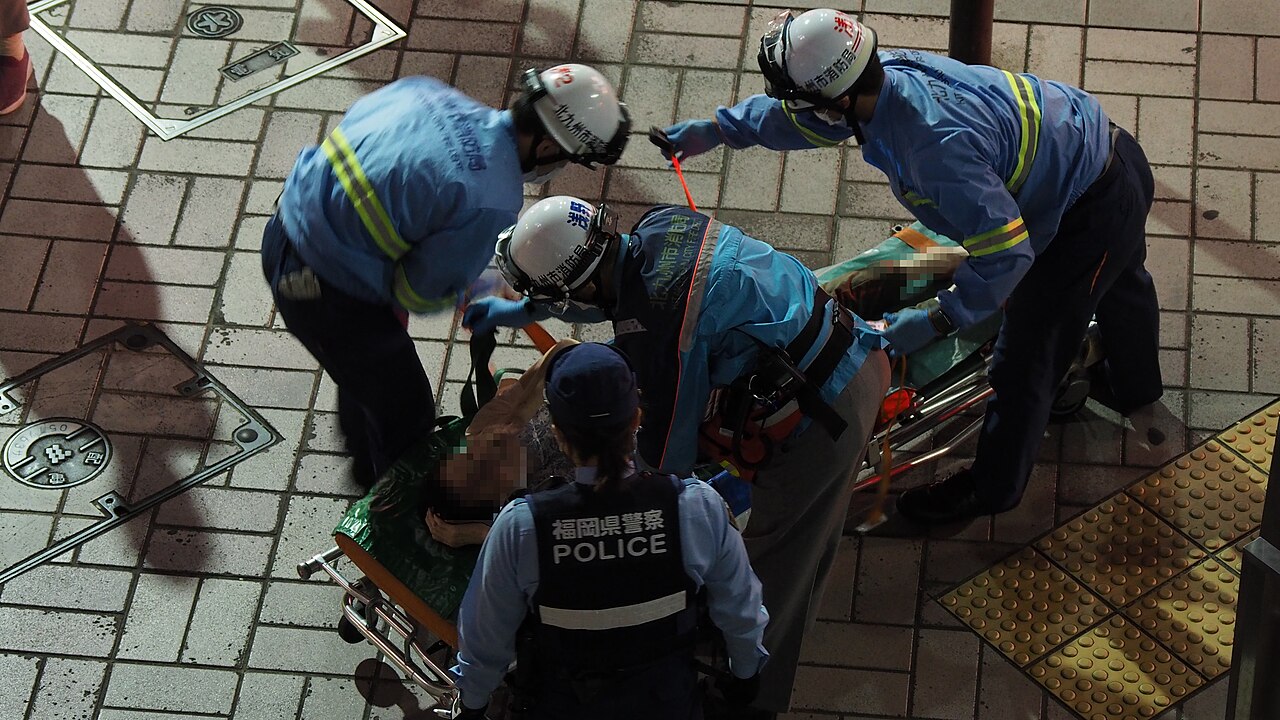 Paramedics shifting patient on stretcher in Delhi